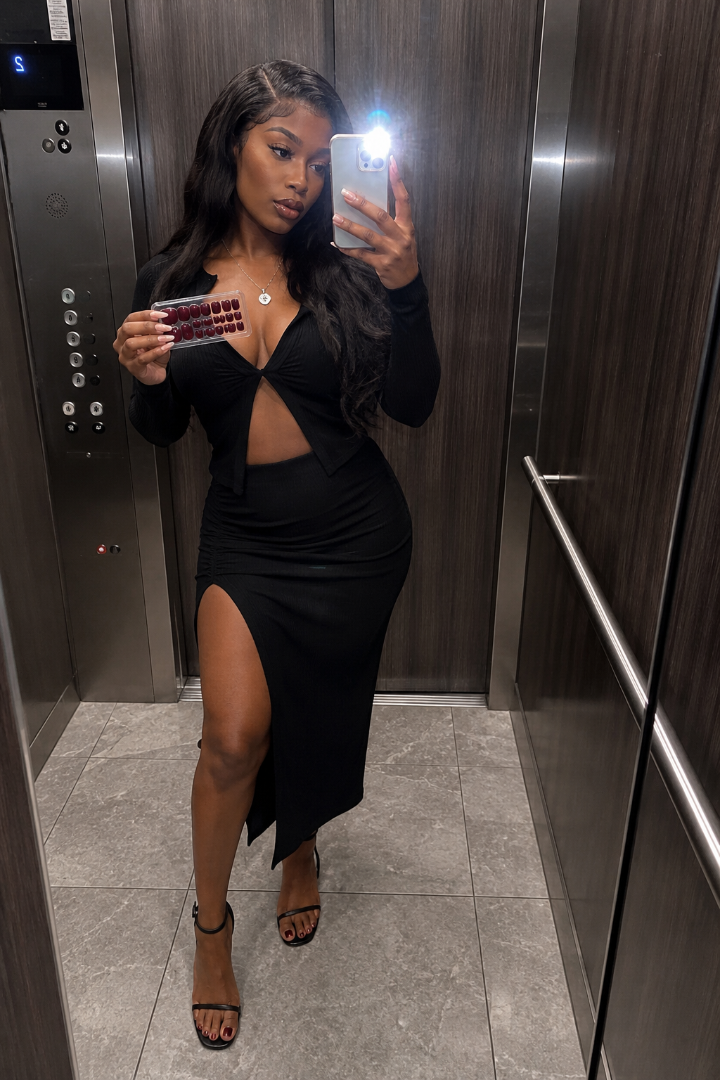Night-out creator elevator mirror selfie holding burgundy press-on nail tray